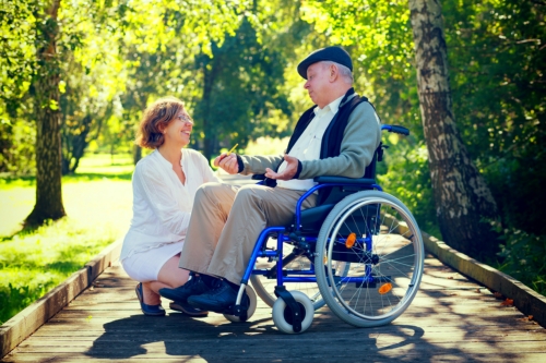 caregiver and senior in a wheelchair